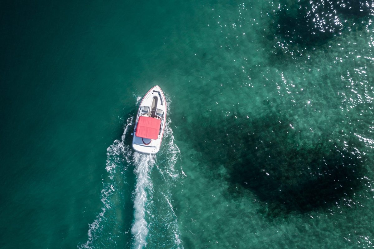Aerial shot of a motorboat moving forward in the sea